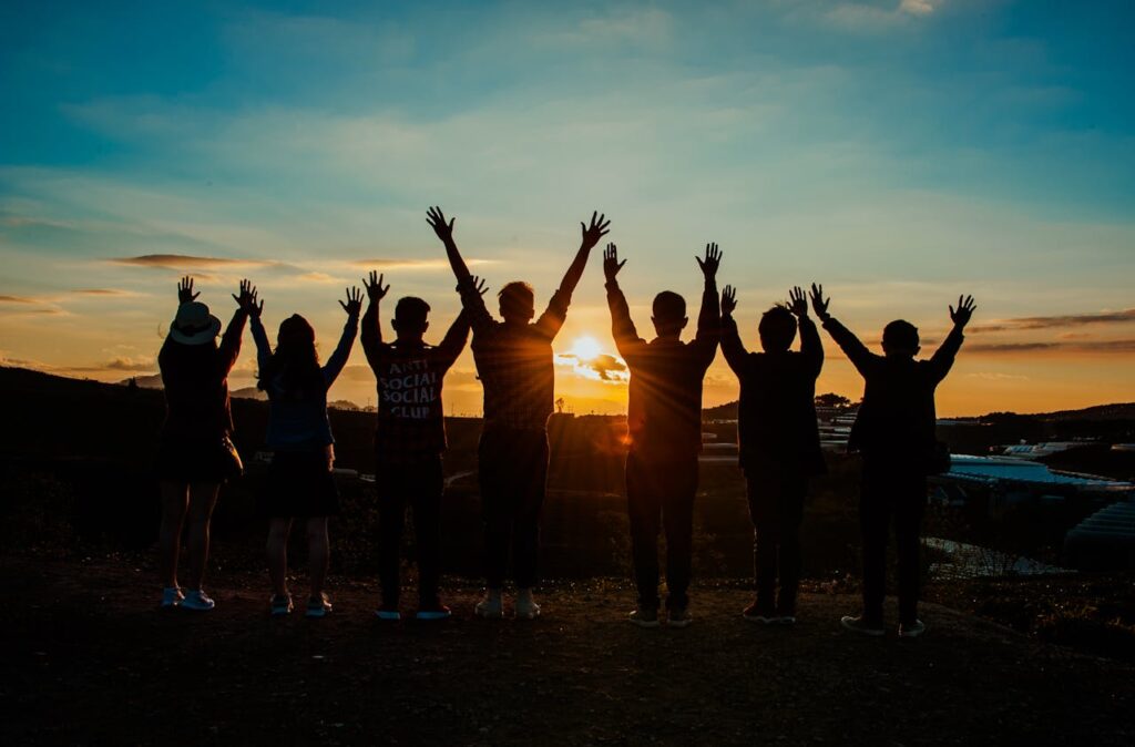 Friends siloes jumping in the sunset